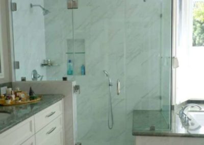 california frameless glass shower door installation in with white marble walls